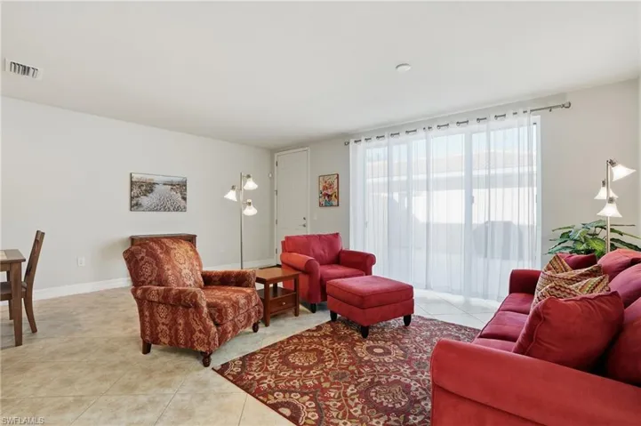 Living area with light tile patterned floors and baseboards
