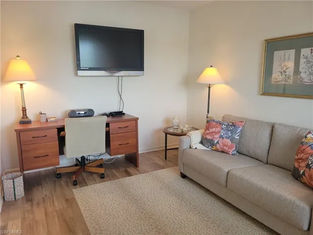 Den with desk and TV