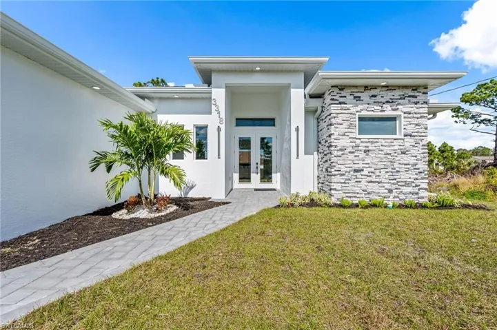 Property entrance with french doors and a lawn