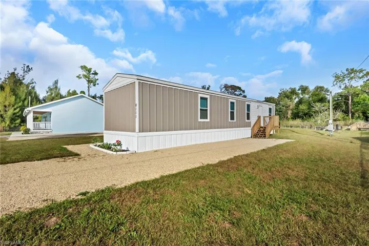View of property exterior with a yard