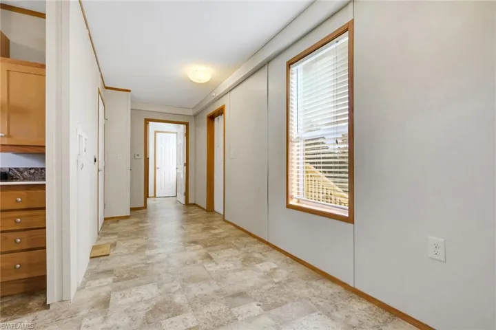 Hall with baseboards and crown molding