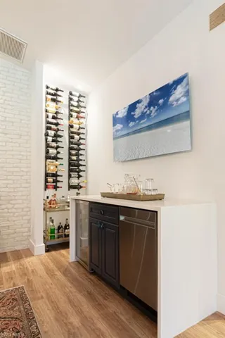 Custom Bar with mini dishwasher and beverage cooler...custom wine wall rack