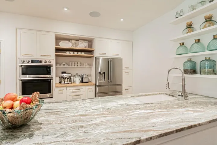 Great view of lovely quartz countertop, view of coffee bar, tons of storage.