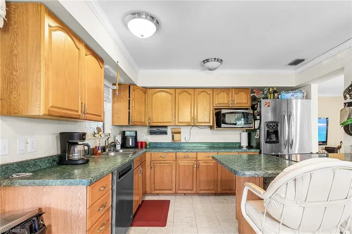 Kitchen with stainless appliances and breakfast bar.