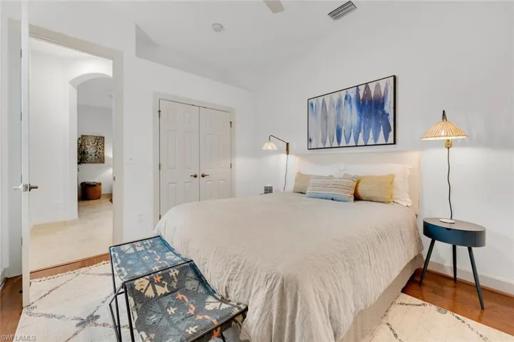 Bedroom with ceiling fan, a closet, and hardwood / wood-style flooring