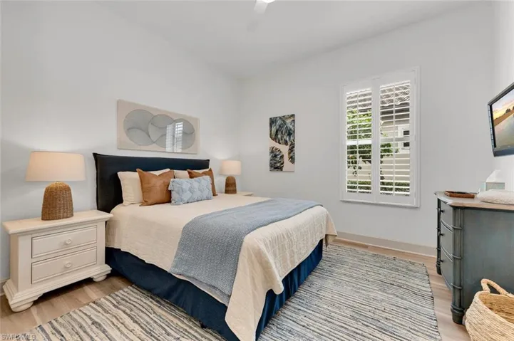 Bedroom featuring ceiling fan and light hardwood / wood-style flooring
