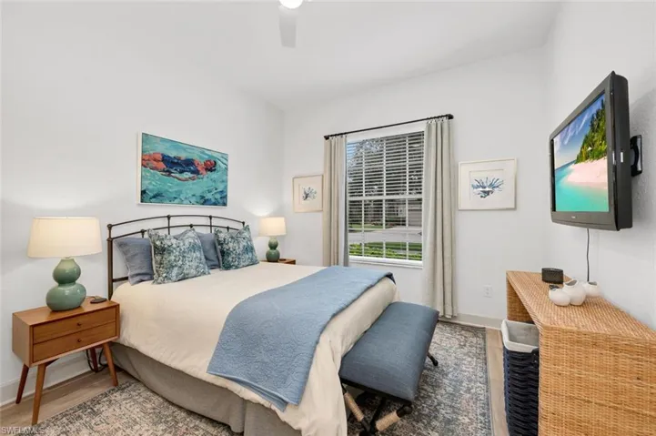 Bedroom with ceiling fan and hardwood / wood-style flooring