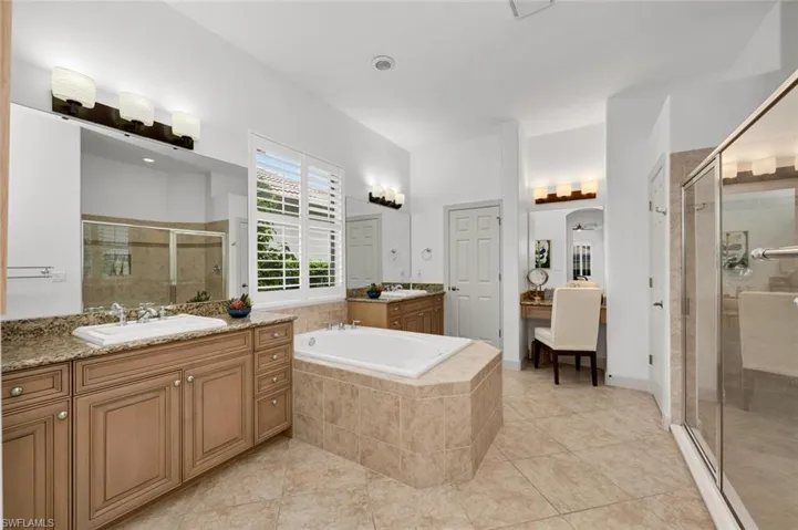 Bathroom featuring separate shower and tub and tile patterned floors