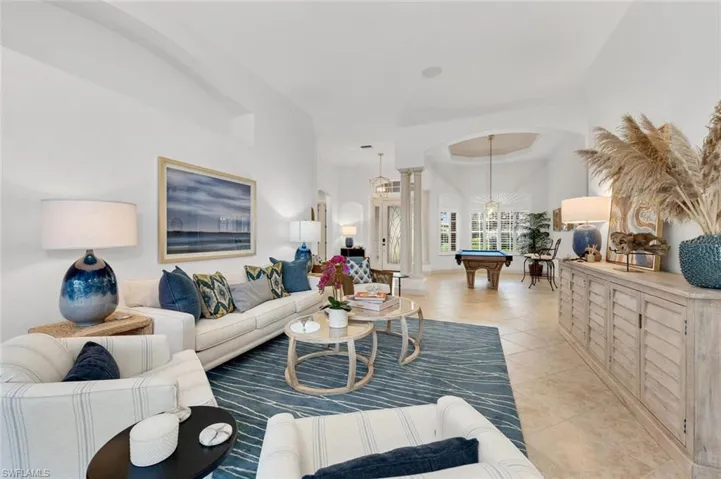 Living room featuring light tile patterned floors and billiards
