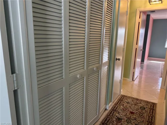 Hallway featuring light tile patterned flooring