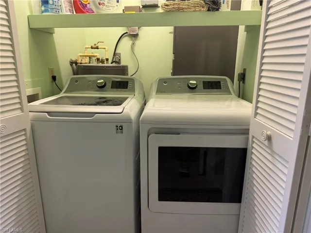 Clothes washing area with washer and dryer and water heater