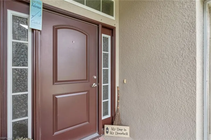 Entrance to property with stucco siding