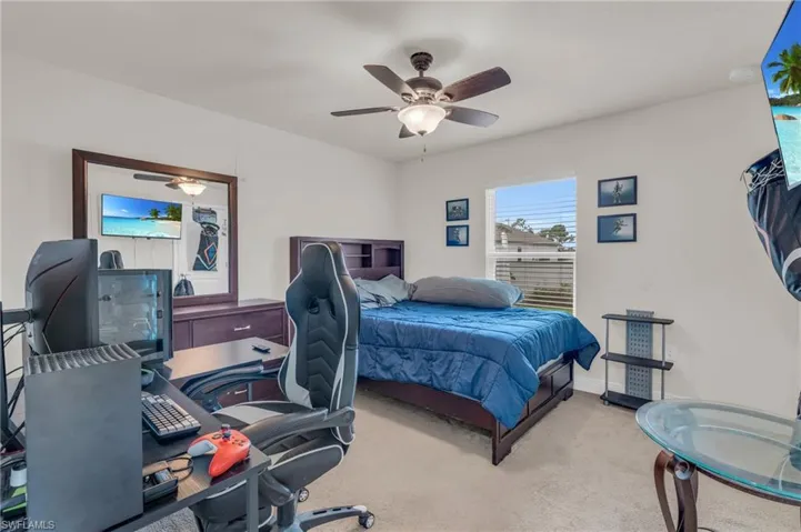 Carpeted bedroom with ceiling fan