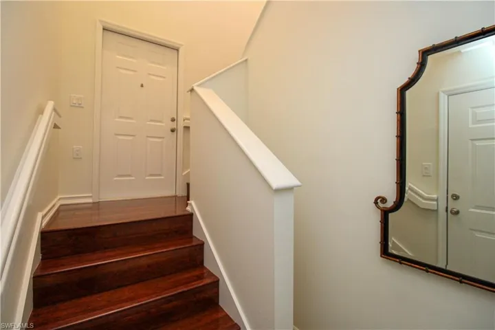 Stairway featuring hardwood / wood-style flooring