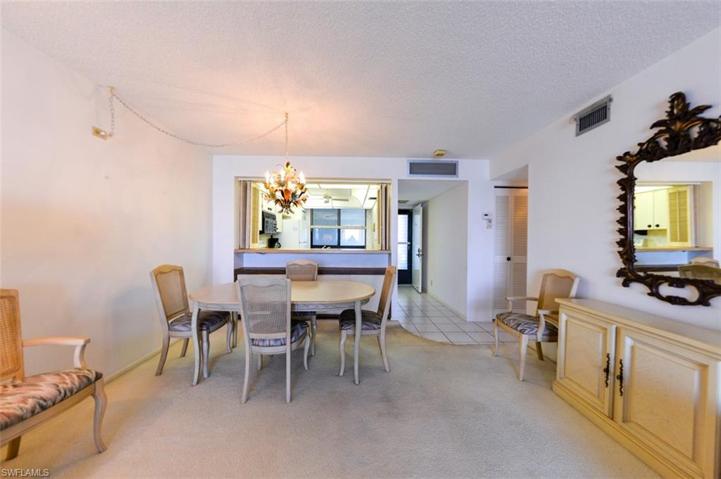 VIEW FROM LIVING AREA TOWARDS DINING, KITCHEN, UNIT ENTRANCE AND GUEST BEDROOM AREAS.