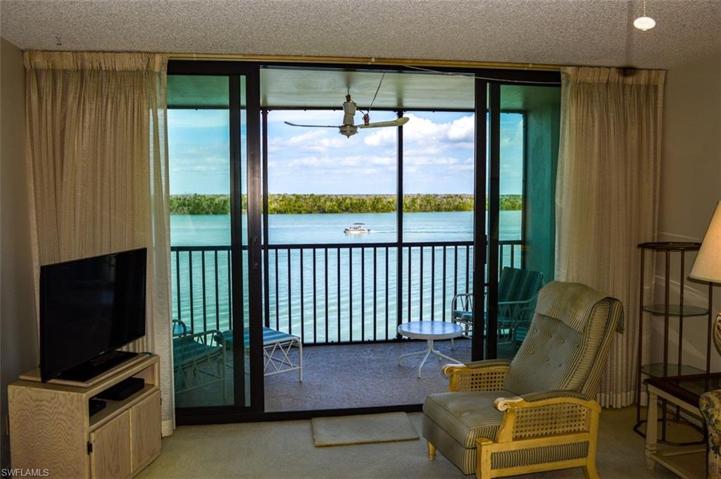 LIVING AREA SHOWING STRIKING ESTERO BAY VIEWS.  LANAI RECENTLY REFURBISHED.