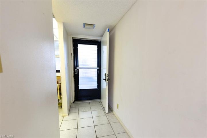 UNIT ENTRY.  ENTRANCE TO KITCHEN IS SHOWN AT LEFT.