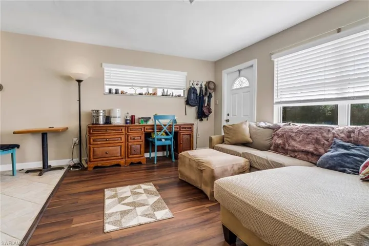 Living area with wood finished floors and baseboards
