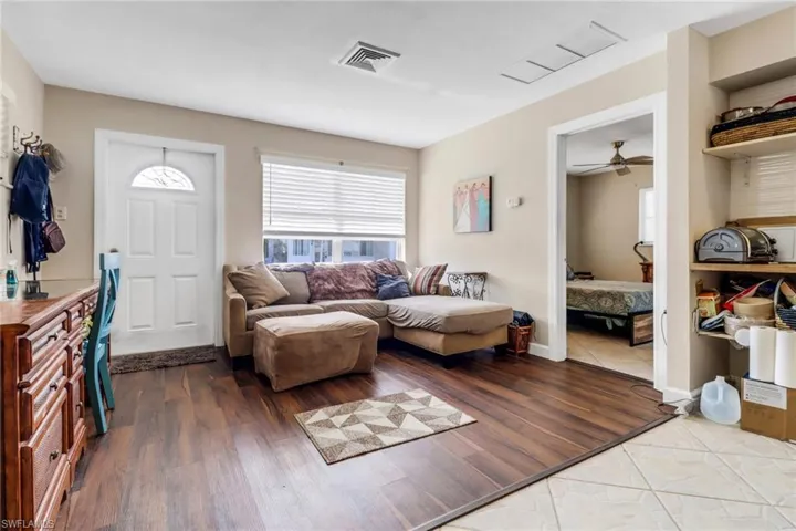 Living area with wood finished floors and ceiling fan
