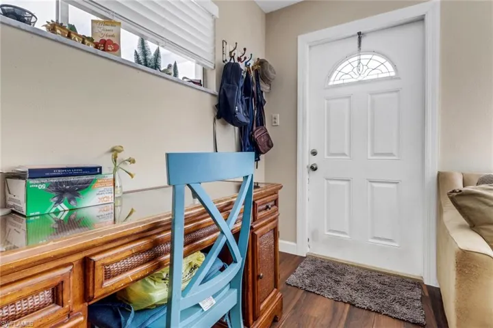 Foyer entrance featuring wood finished floors and baseboards