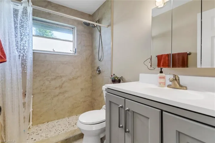Bathroom with vanity and a tile shower