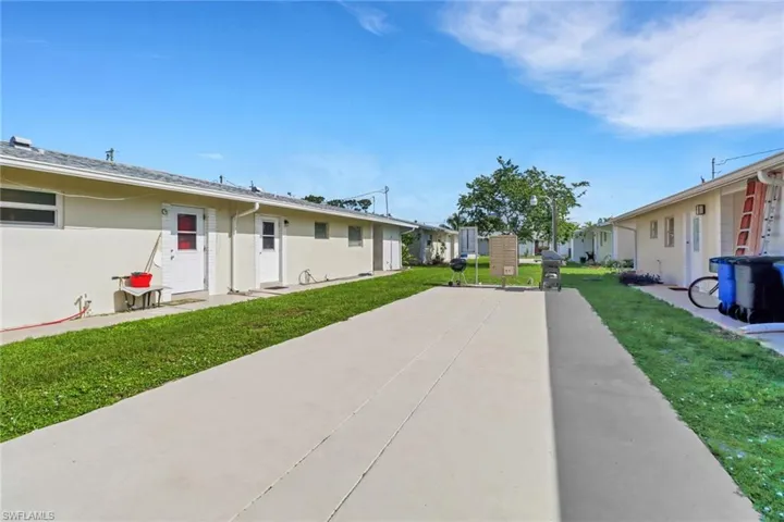 View of grassy yard featuring a patio area