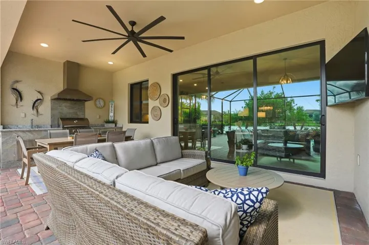 View of patio with exterior kitchen, outdoor lounge area, a ceiling fan, and outdoor dining space