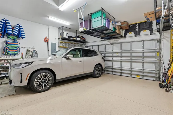 Garage featuring electric panel and a garage door opener