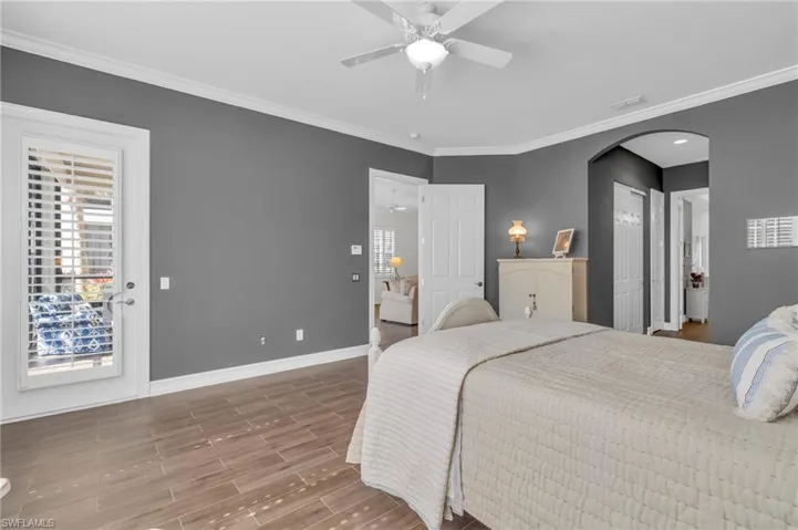 Bedroom featuring ornamental molding, hardwood / wood-style floors, and ceiling fan
