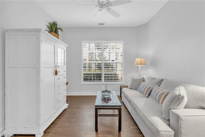 Living room featuring hardwood / wood-style flooring and ceiling fan