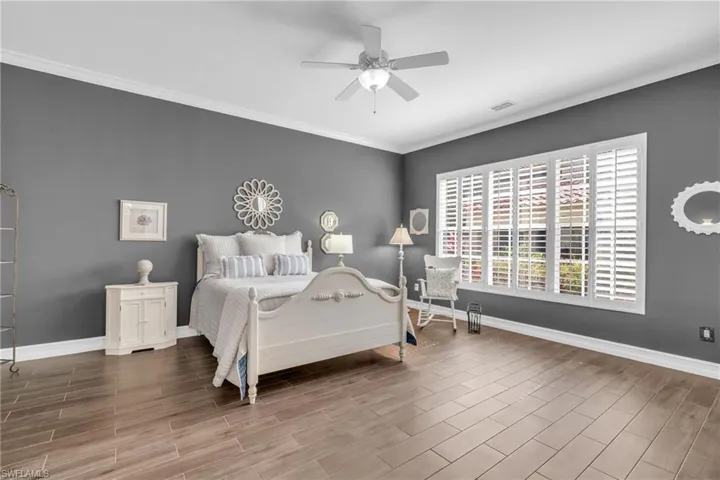 Bedroom featuring crown molding, ceiling fan, and hardwood / wood-style floors