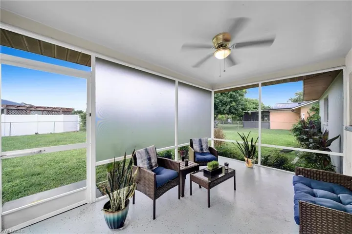 Sunroom / solarium with ceiling fan and a healthy amount of sunlight