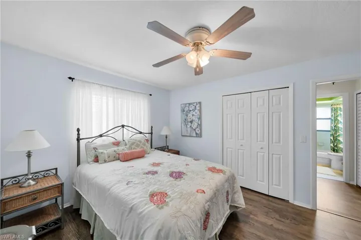 Bedroom featuring ceiling fan, a closet, and dark wood-type flooring