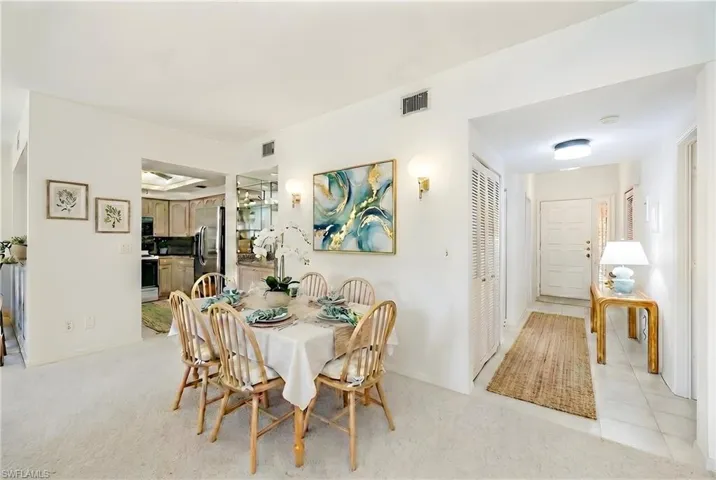 Dining room with light carpet and baseboards