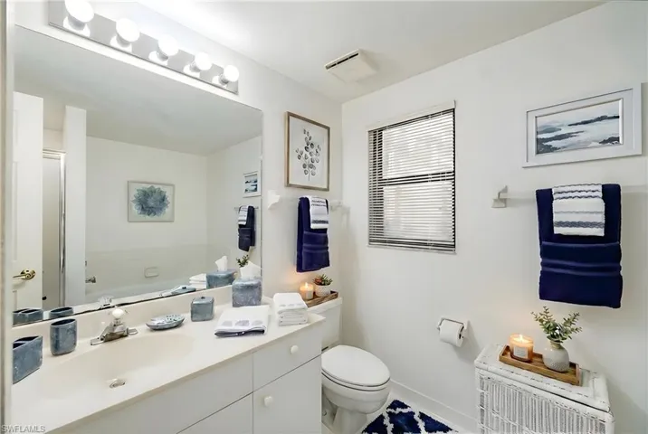 Bathroom featuring a garden tub, vanity, and a shower with shower door