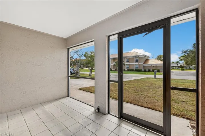 Unfurnished sunroom featuring a residential view