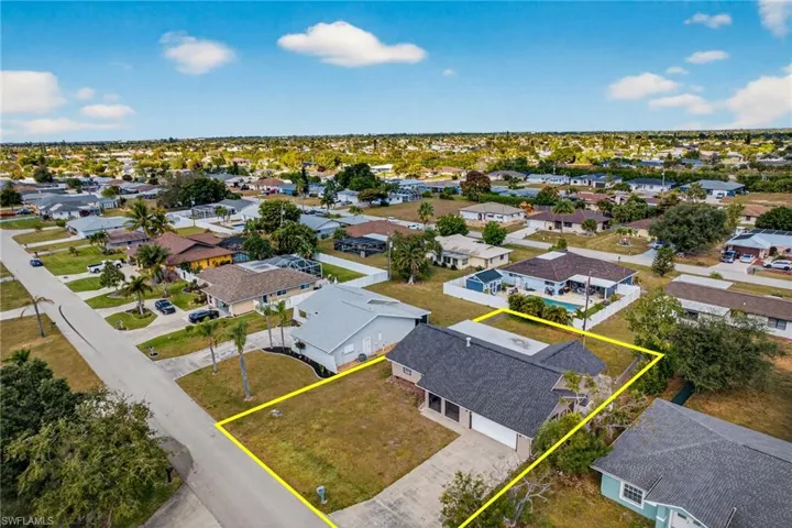 Aerial view of residential area with property boundaries highlighted
