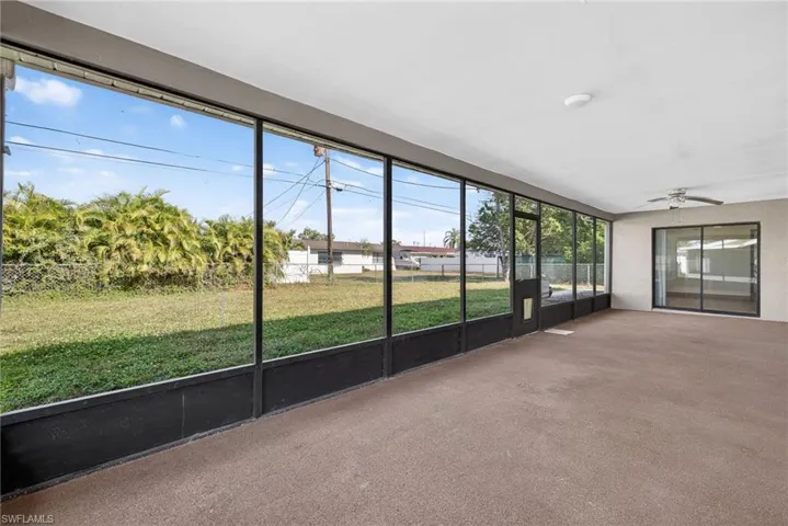 Unfurnished sunroom featuring ceiling fan