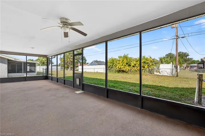 Unfurnished sunroom with a ceiling fan