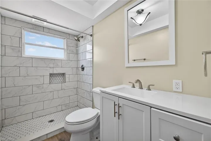 Bathroom featuring a shower stall and vanity