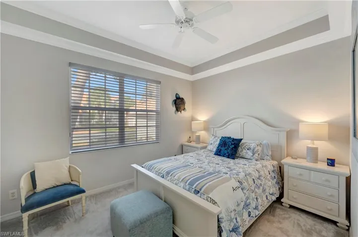 Bedroom with crown molding, light carpet, and ceiling fan