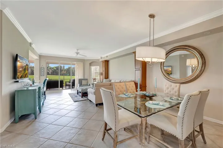 Dining area featuring crown molding, light tile floors, and ceiling fan