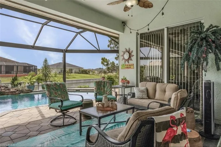 Sunroom with a pool, plenty of natural light, and ceiling fan