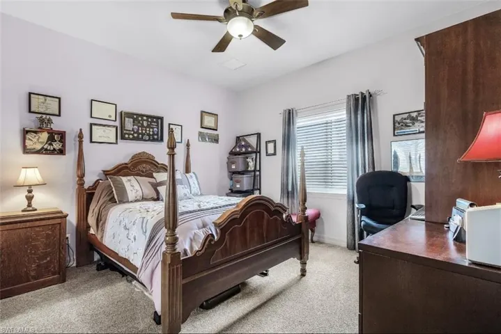 Carpeted bedroom with ceiling fan