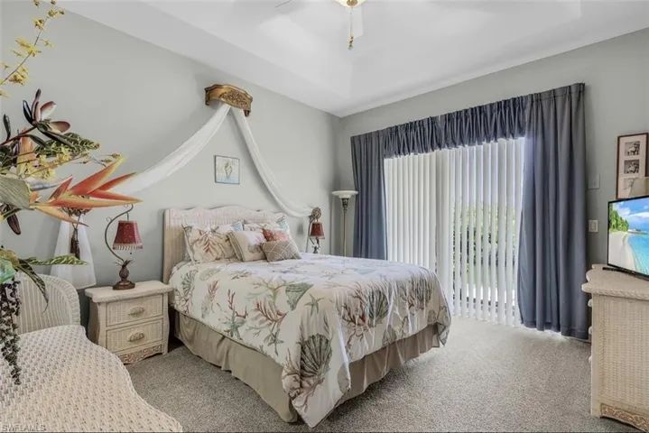 Bedroom featuring ceiling fan and carpet