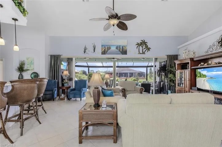 Living room with ceiling fan and vaulted ceiling