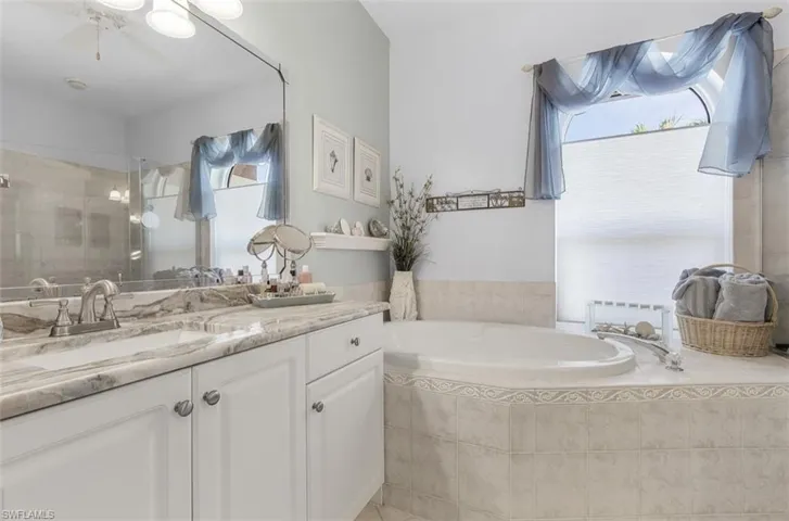 Bathroom with vanity and plus walk in shower