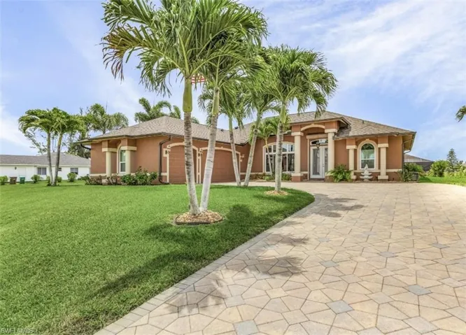 Mediterranean / spanish-style house with a front lawn and a garage