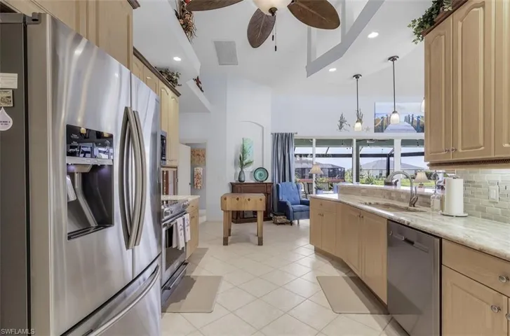Kitchen featuring sink, appliances with stainless steel finishes, backsplash, and light brown cabinets