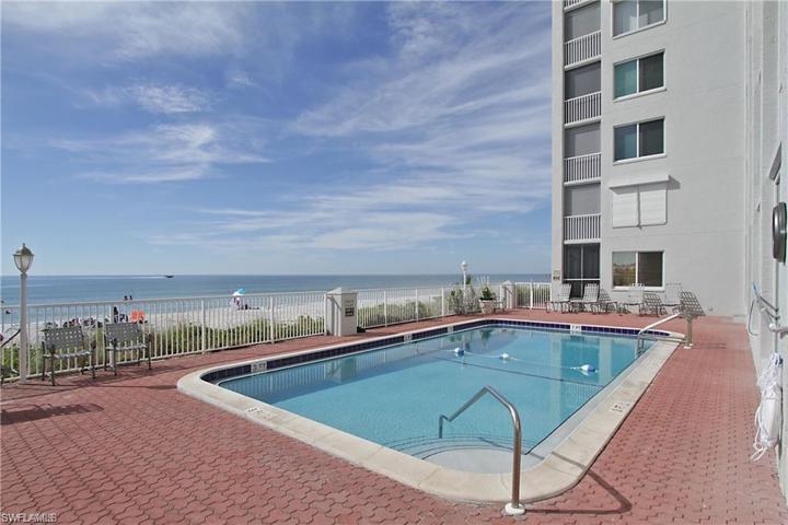 Spacious pool area with additional sunning areas.